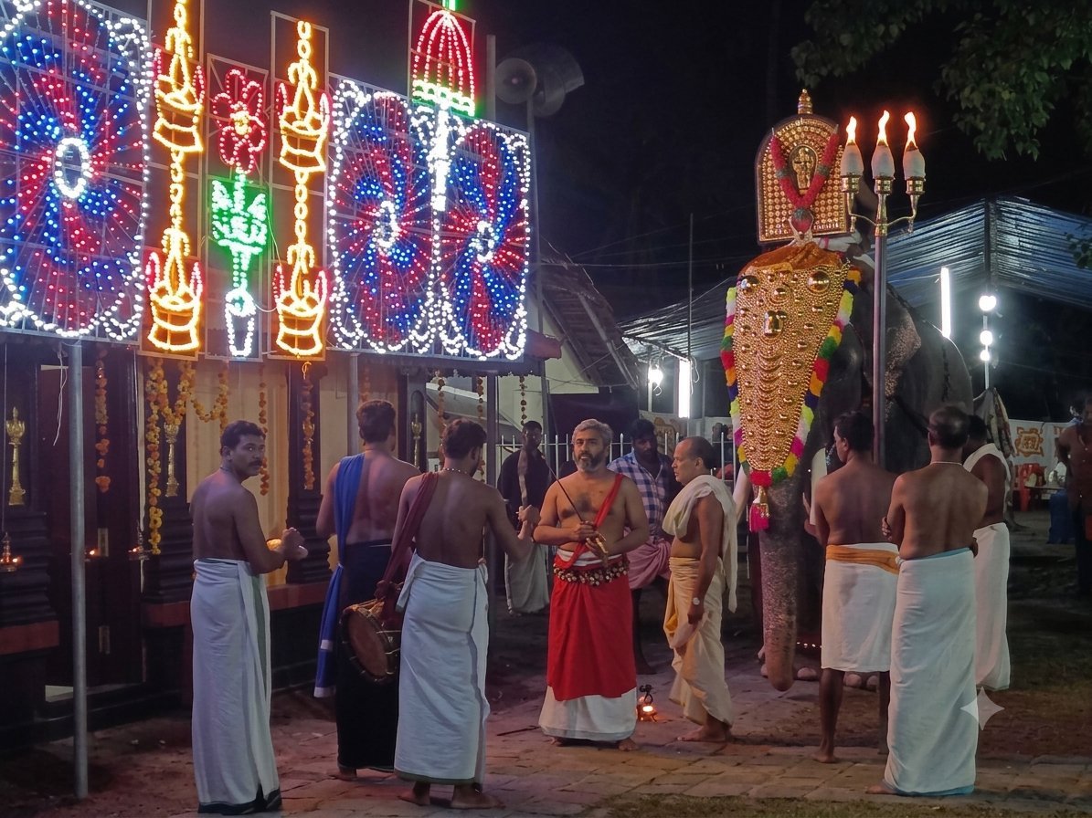 Thalappoli Vilakkinezhunnullippu at night - caparisoned elephant with nettipattam and thidambu, illuminated festival light panels and temple musicians